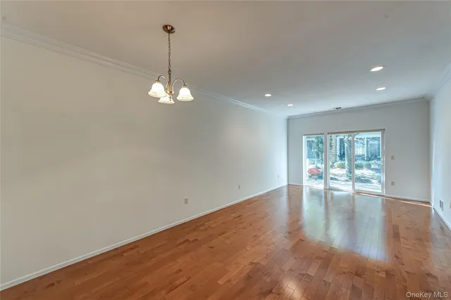 a view of a room with window wooden floor and white walls