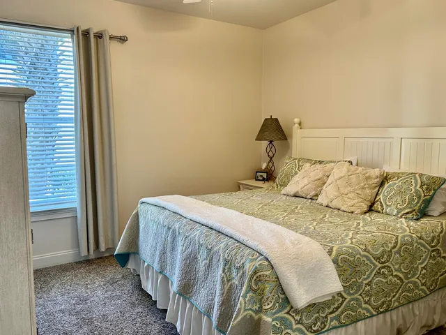 a bedroom with a bed and a window