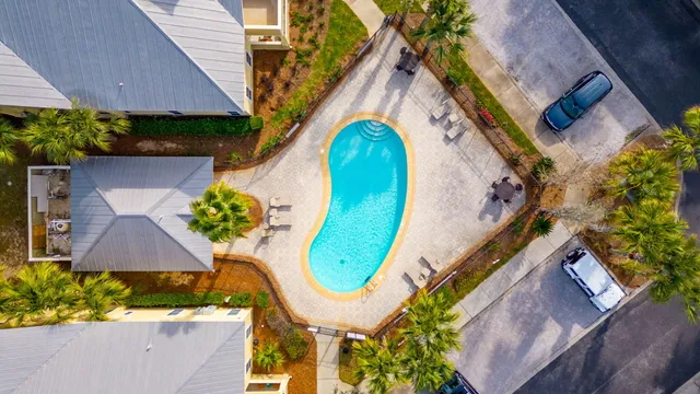 an aerial view of a house with a swimming pool