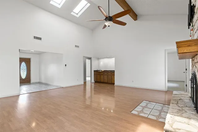 wooden floor in an empty room with a window
