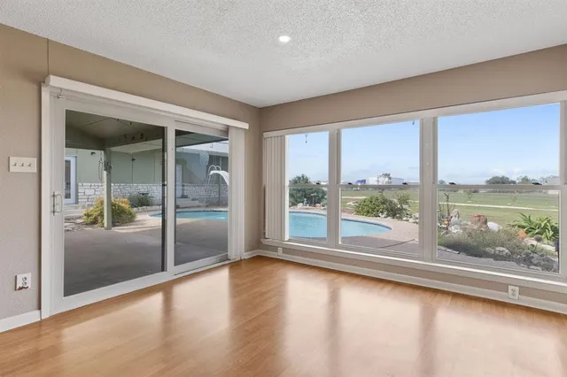 a view of room with window and wooden floor