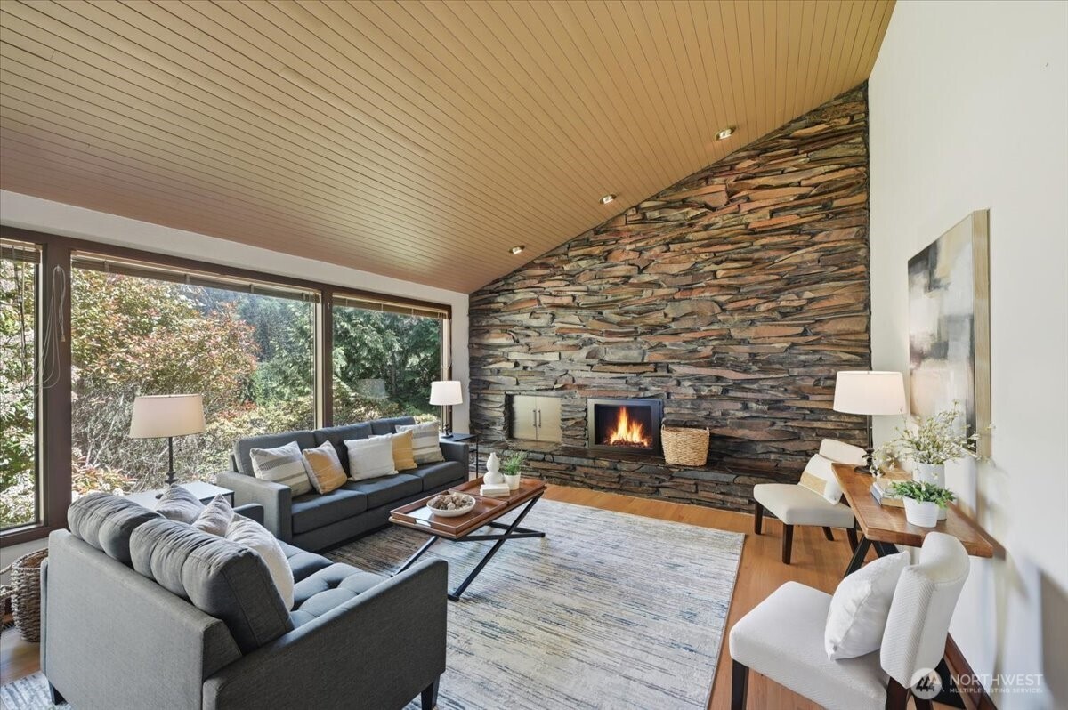 9418 Odin Way Bothell, WA 98011 - Photo 13 of 39 a living room with furniture and a fireplace