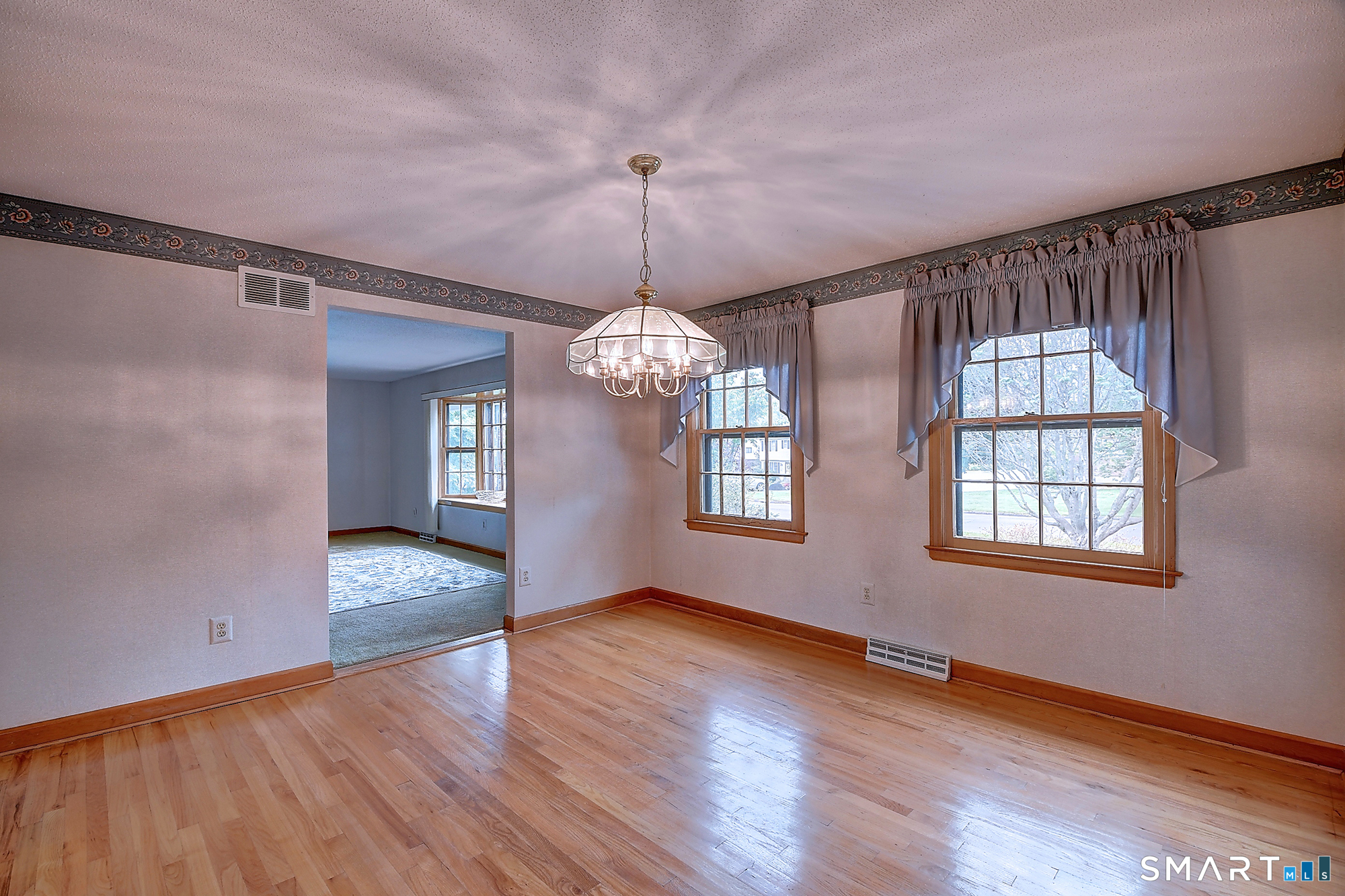80 Grist Mill Road Wethersfield, CT 06109 - Photo 11 of 40 a view of an empty room with wooden floor and a window
