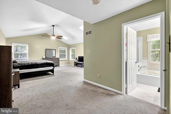 a view of a bedroom with furniture and window