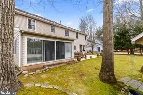 a view of a house with pool and sitting area