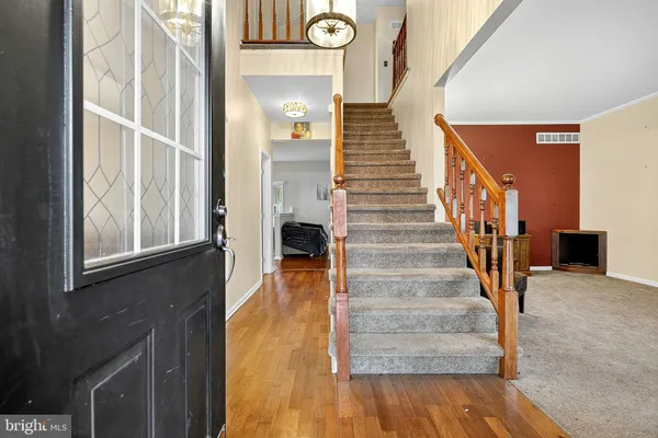 a view of entryway and hall with wooden floor