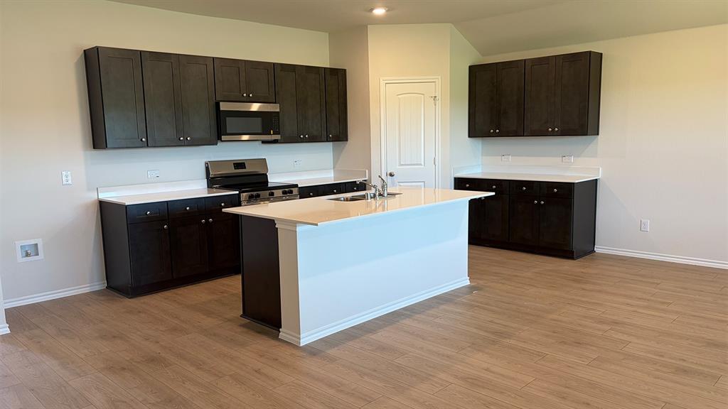 2007 Reveille Way Terrell, TX 75160 - Photo 16 of 31 a kitchen with stainless steel appliances granite countertop a stove a sink and a microwave