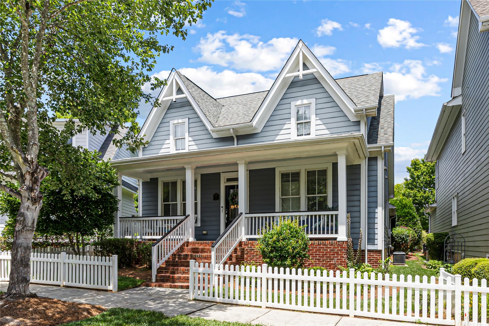 126 Blandina Court Fort Mill, SC 29708 - Photo 1 of 33 a view of a white house with large windows plants and large trees