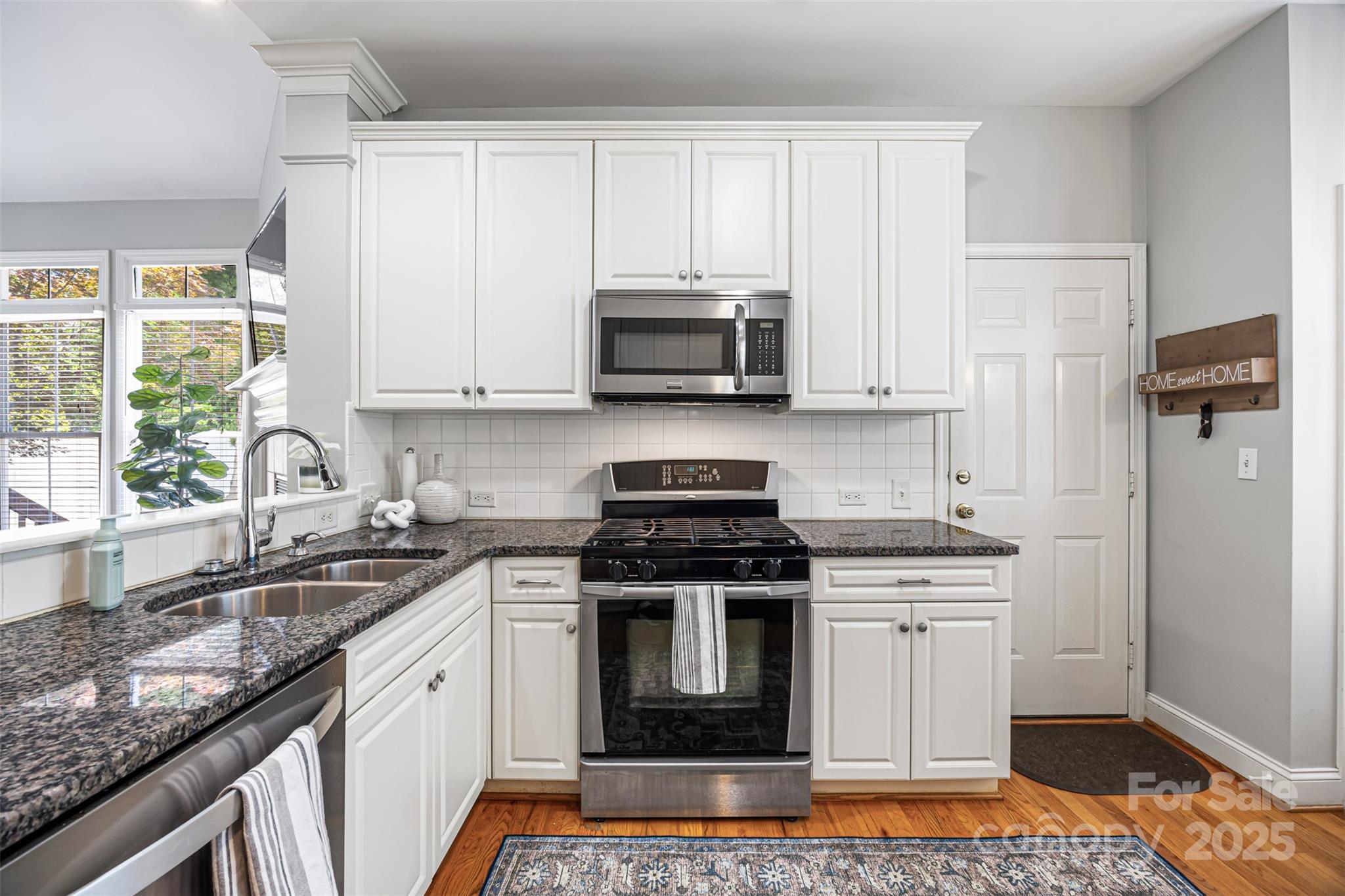 126 Blandina Court Fort Mill, SC 29708 - Photo 11 of 33 a kitchen with stainless steel appliances granite countertop a stove a sink and a microwave