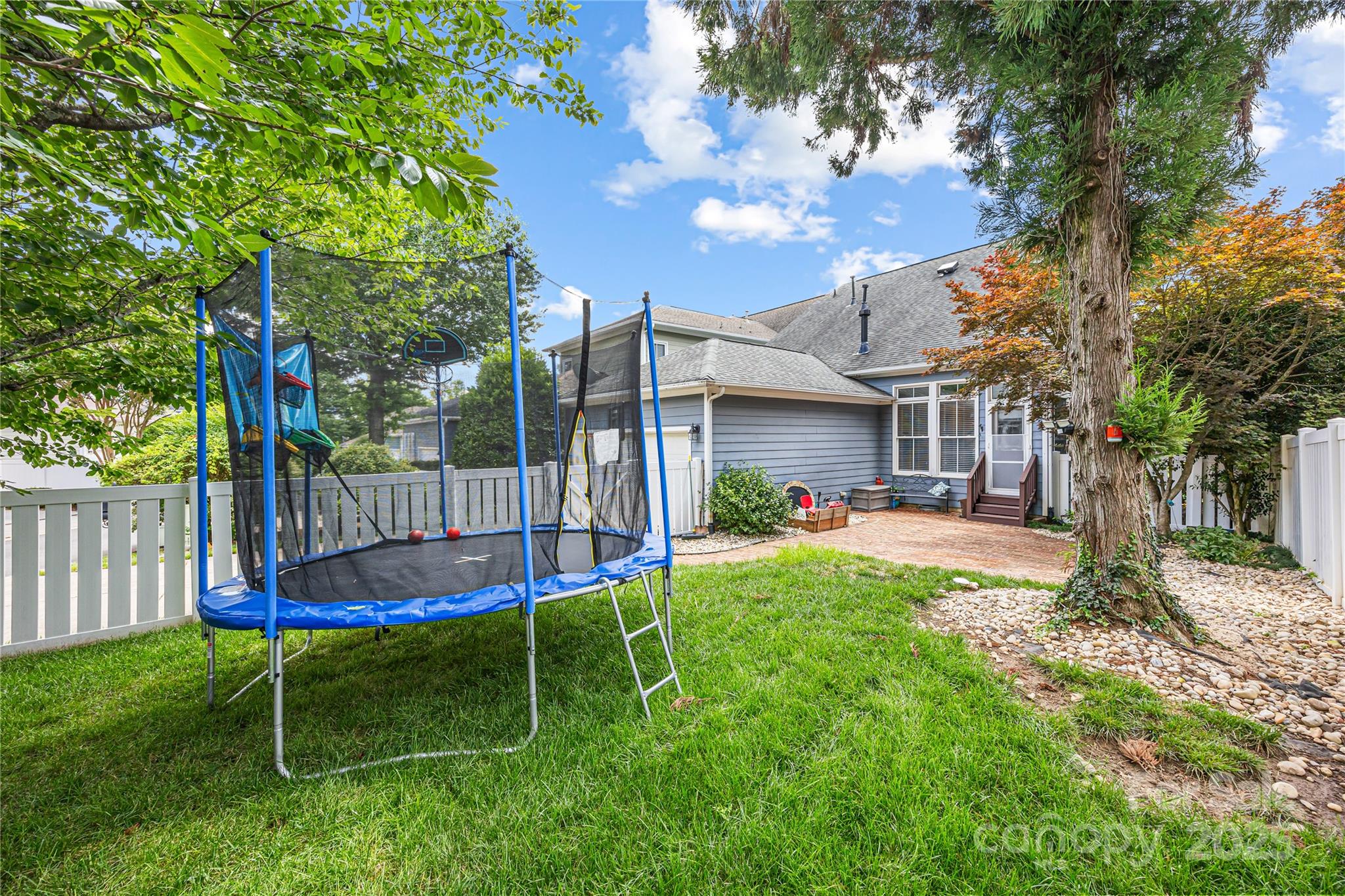 126 Blandina Court Fort Mill, SC 29708 - Photo 24 of 33 a view of a backyard with a slide trees and wooden fence