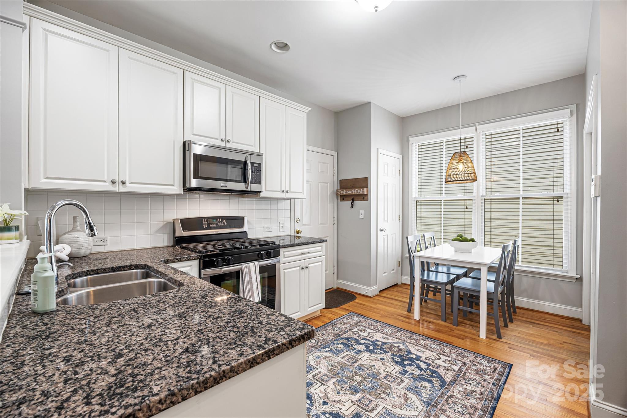 126 Blandina Court Fort Mill, SC 29708 - Photo 10 of 33 a kitchen with a stove a sink and a microwave