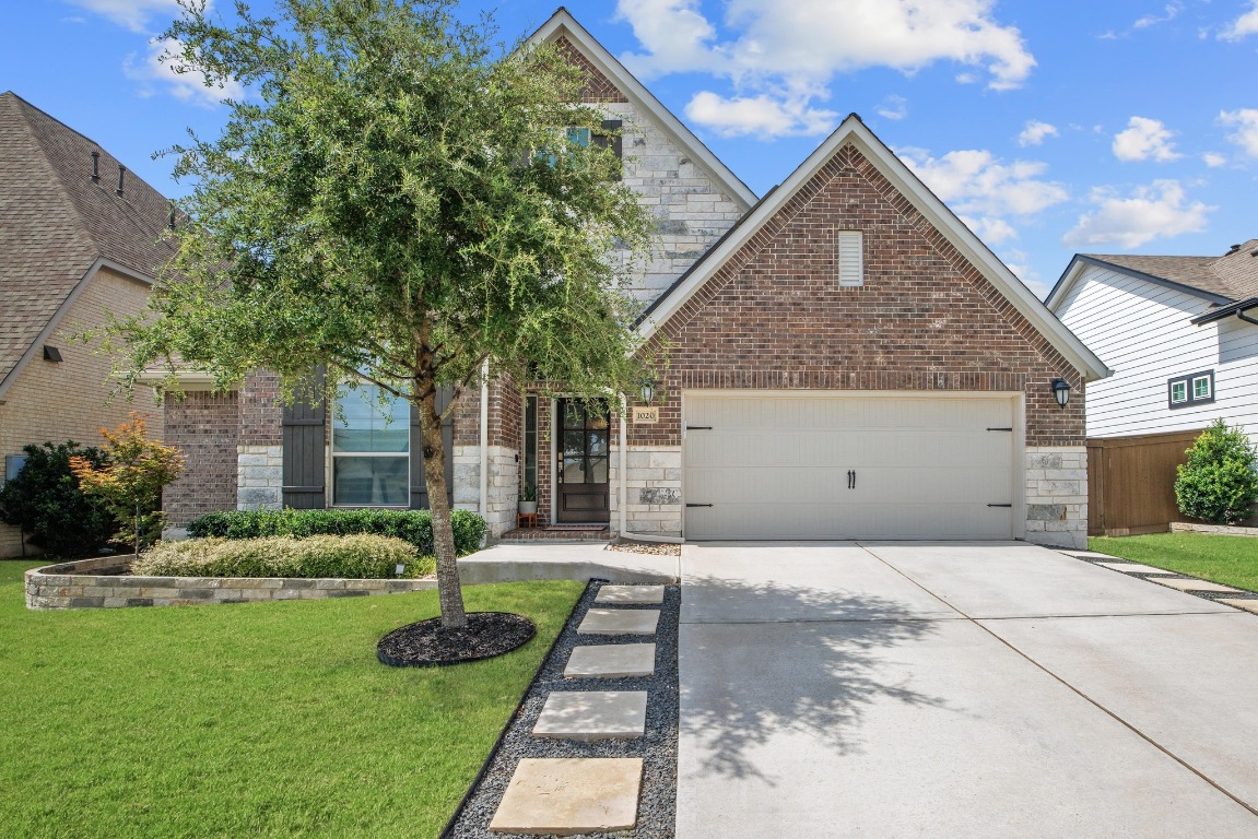 1020 Quarry Point Pass Leander, TX 78641 - Photo 1 of 1 a front view of a house with a yard
