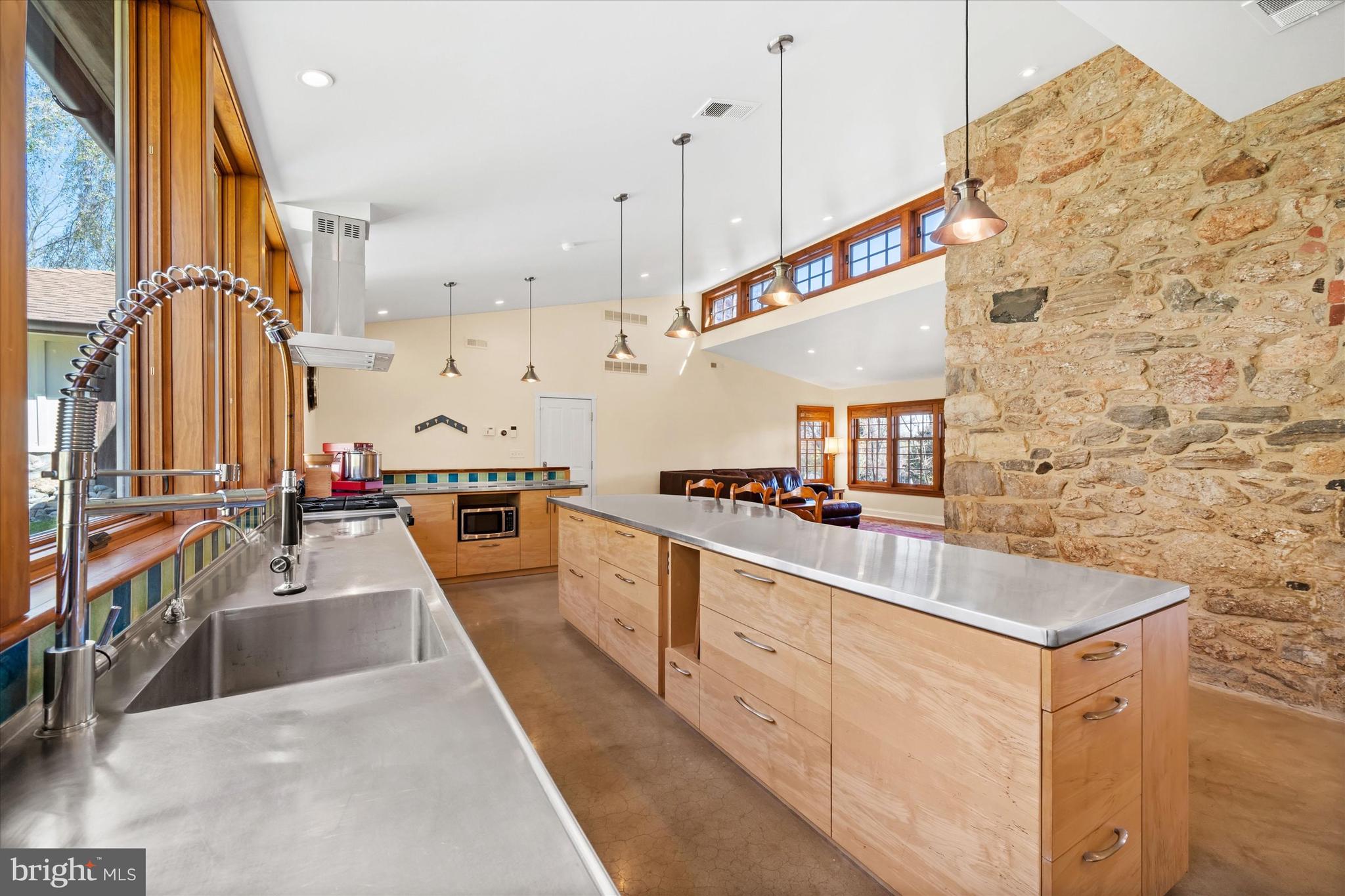 1439 Old Wilmington Road Hockessin, DE 19707 - Photo 19 of 57 a kitchen with stainless steel appliances kitchen island granite countertop a sink and a refrigerator