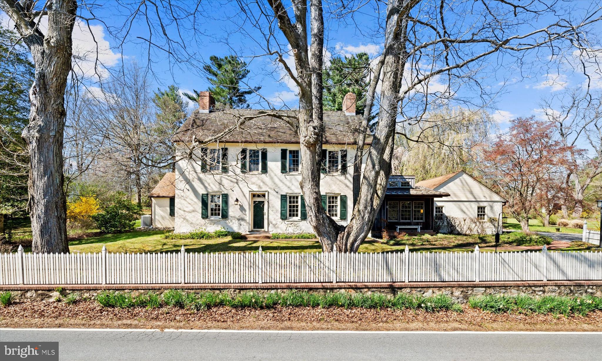 1439 Old Wilmington Road Hockessin, DE 19707 - Photo 2 of 57 a front view of a house with a garden and tree
