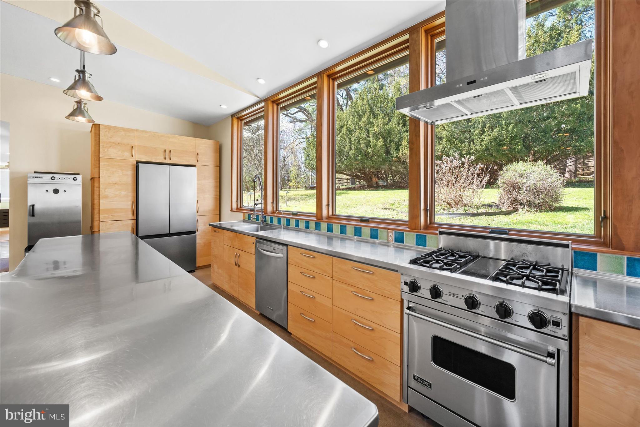 1439 Old Wilmington Road Hockessin, DE 19707 - Photo 21 of 57 a kitchen with stainless steel appliances a stove cabinets and a counter top space