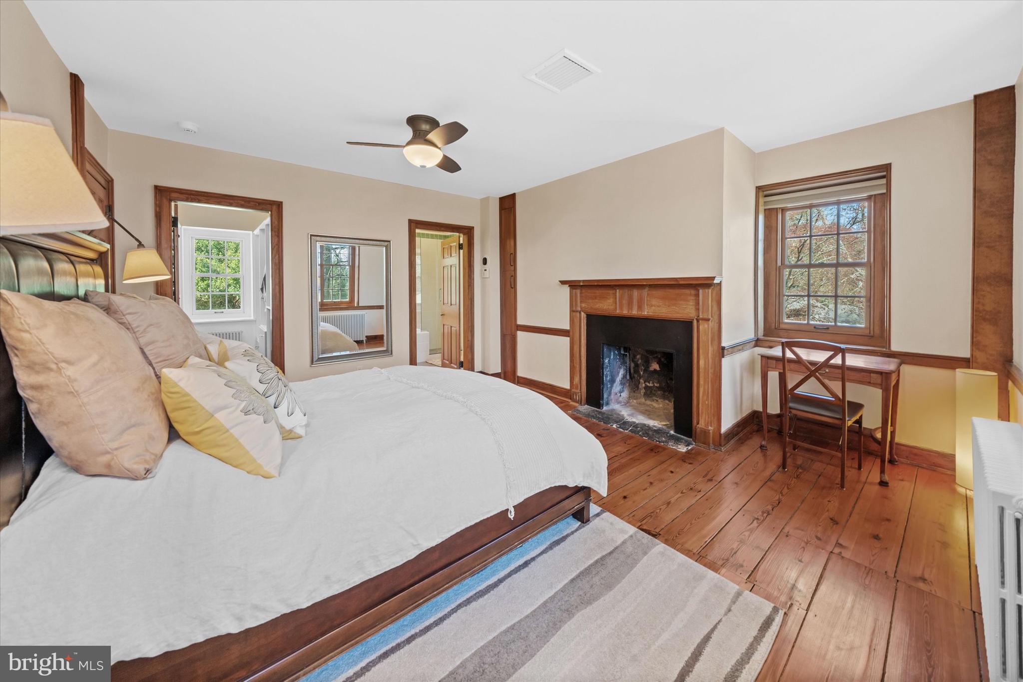 1439 Old Wilmington Road Hockessin, DE 19707 - Photo 32 of 57 a spacious bedroom with a bed and a fireplace