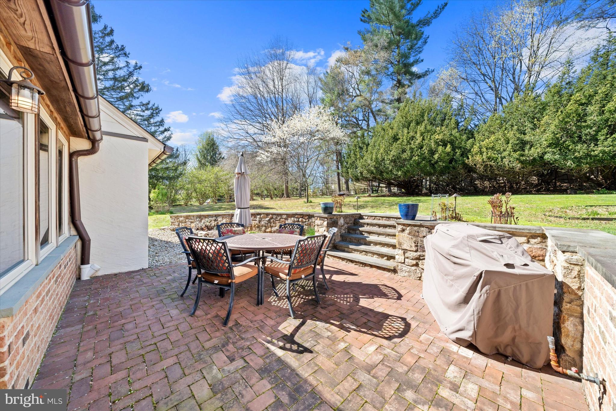 1439 Old Wilmington Road Hockessin, DE 19707 - Photo 41 of 57 a view of a patio with table and chairs and potted plants