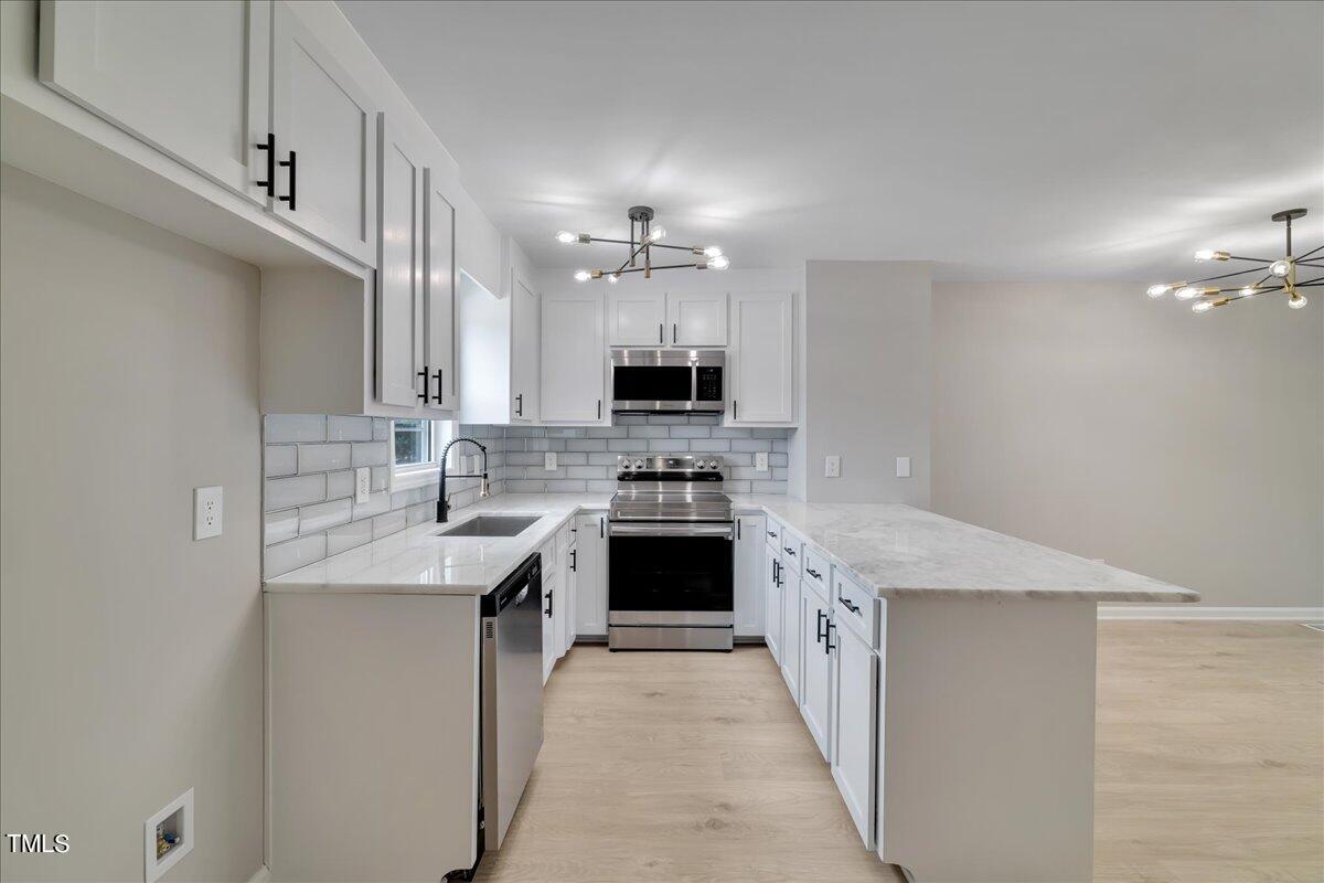 403 East Williams Street Angier, NC 27501 - Photo 1 of 38 a large kitchen with a stove top oven and sink