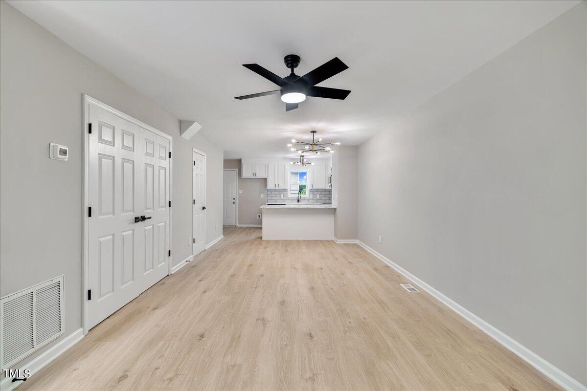 403 East Williams Street Angier, NC 27501 - Photo 12 of 38 a view of empty room with wooden floor
