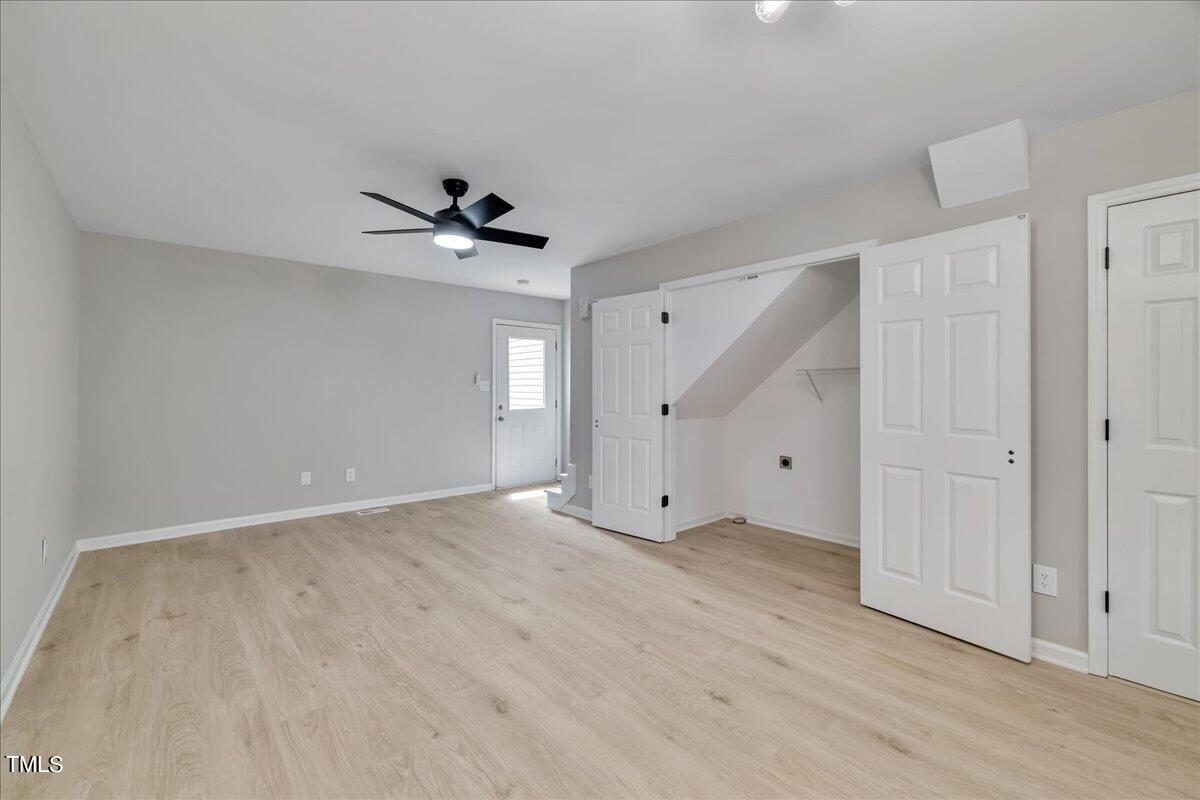 403 East Williams Street Angier, NC 27501 - Photo 13 of 38 an empty room with fan and windows