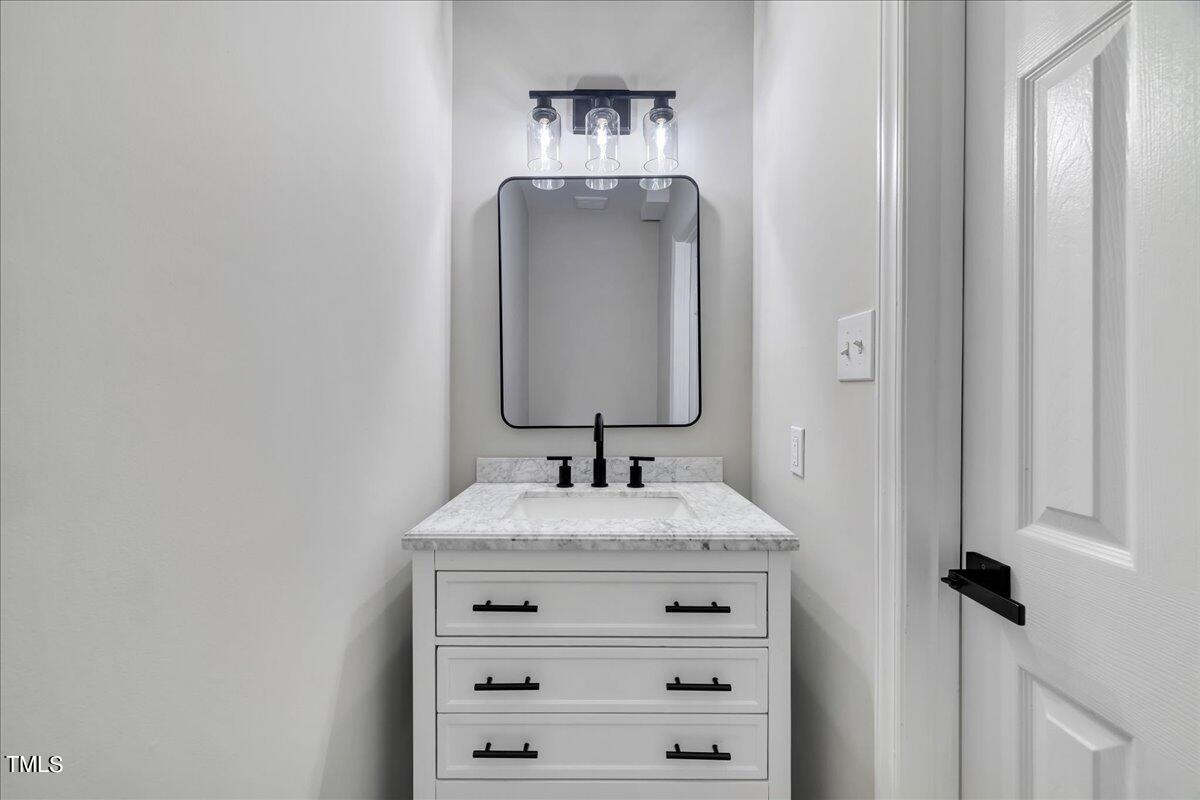 403 East Williams Street Angier, NC 27501 - Photo 15 of 38 a sink with a mirror