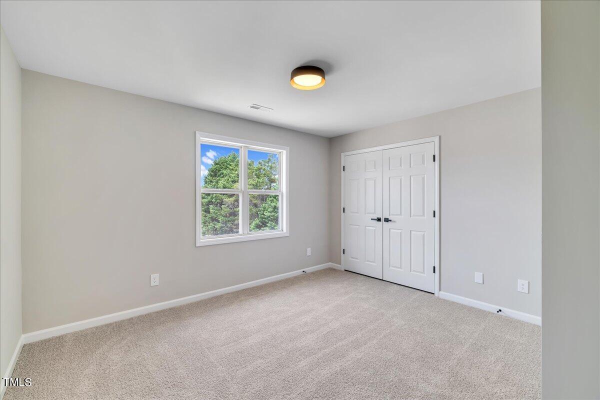 403 East Williams Street Angier, NC 27501 - Photo 18 of 38 a view of an empty room with a window