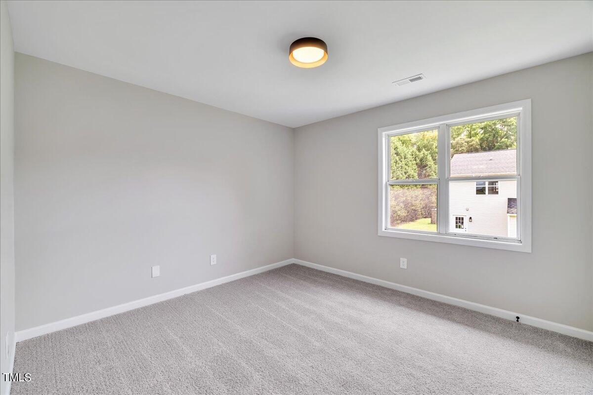 403 East Williams Street Angier, NC 27501 - Photo 23 of 38 an empty room with a window