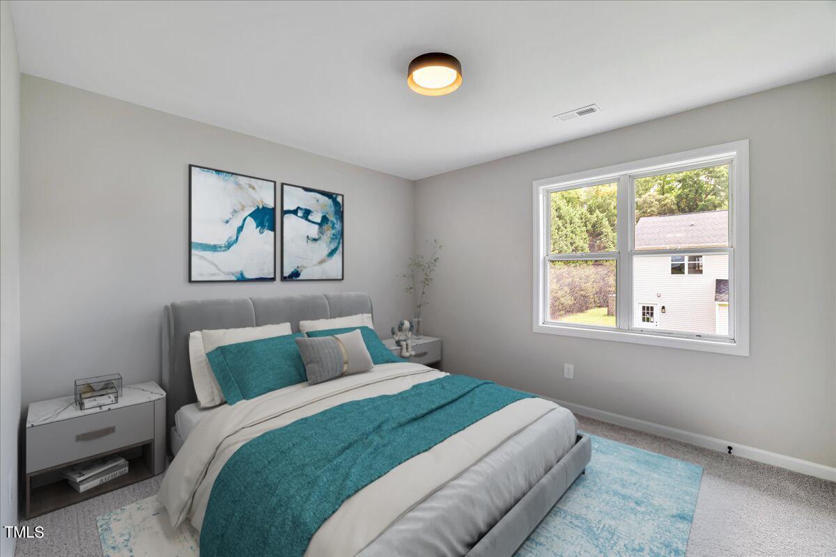 403 East Williams Street Angier, NC 27501 - Photo 5 of 38 a bedroom with a bed and a painting on the wall