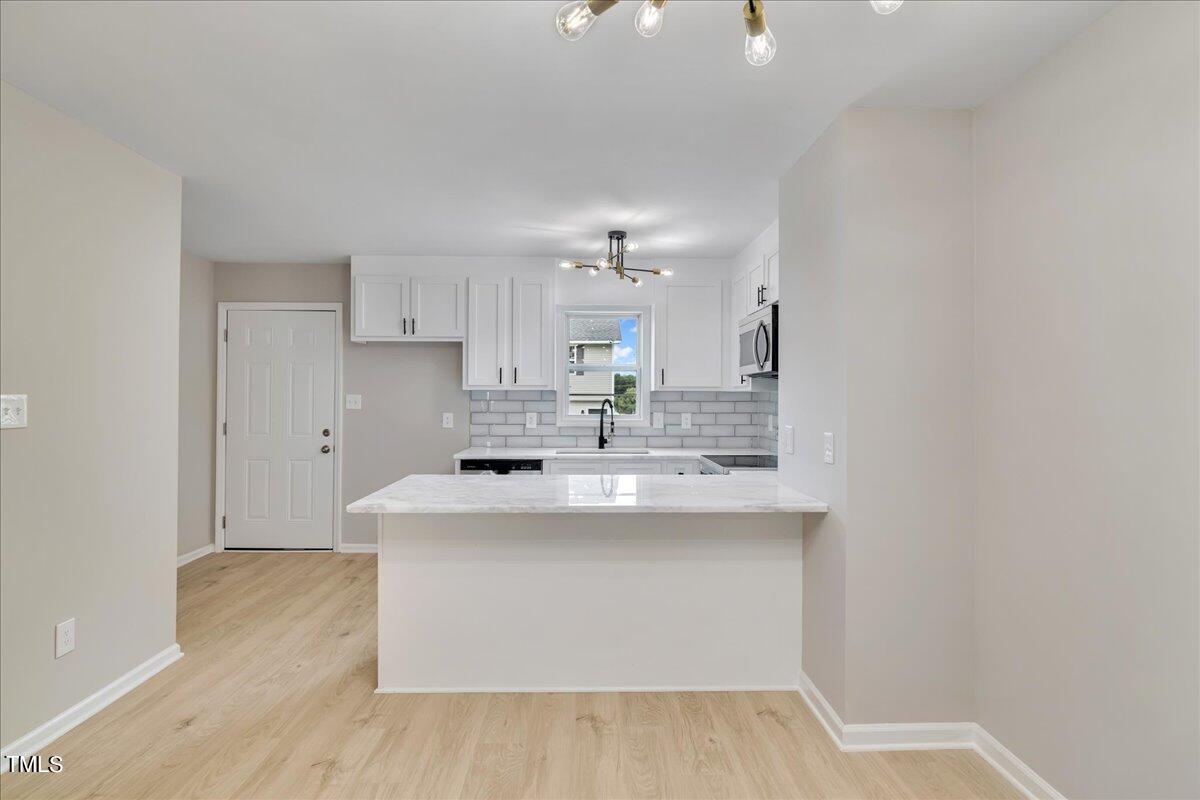 403 East Williams Street Angier, NC 27501 - Photo 6 of 38 a kitchen with kitchen island sink stove and cabinets