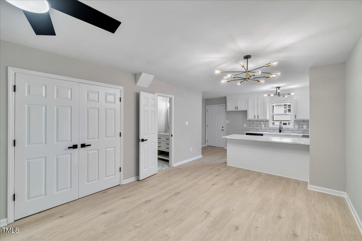 403 East Williams Street Angier, NC 27501 - Photo 7 of 38 a large white kitchen with a white cabinet and chandelier