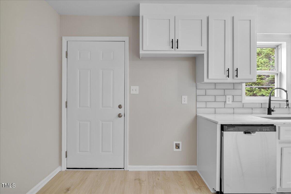 403 East Williams Street Angier, NC 27501 - Photo 9 of 38 a kitchen with white cabinets and a sink