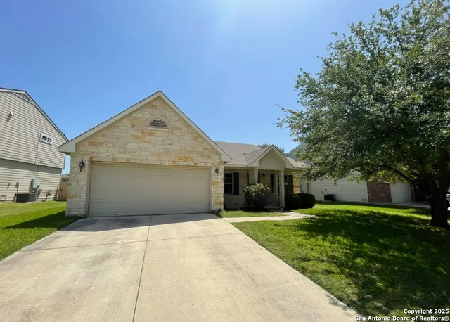 a front view of house with yard and green space