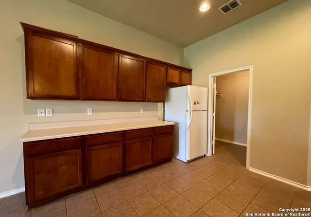 a kitchen with a sink and a refrigerator