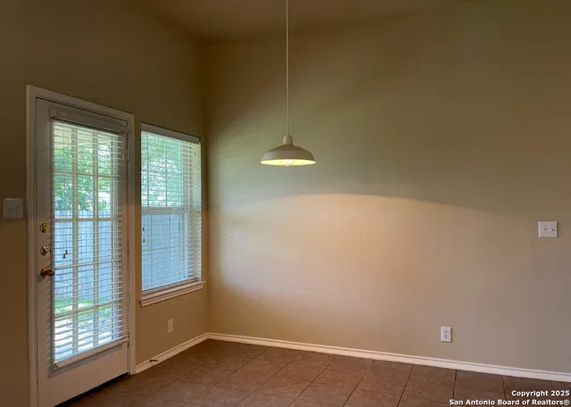 a view of a room with furniture and windows