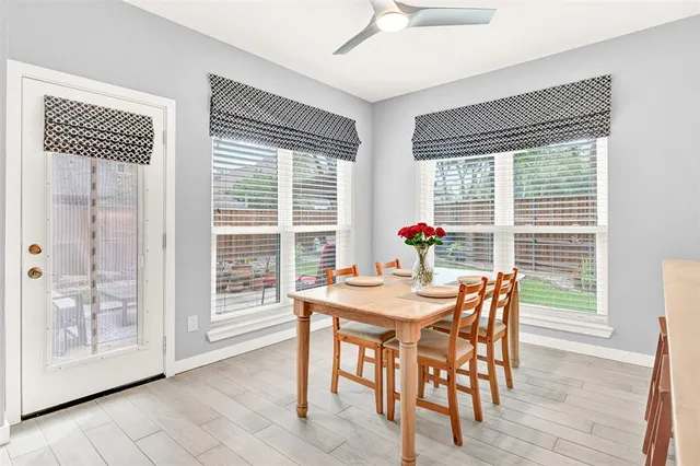 a living room with furniture and large windows