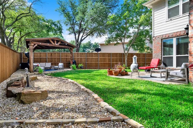 front view of a brick house with a yard