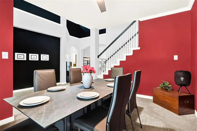 a living room with furniture and a book shelf