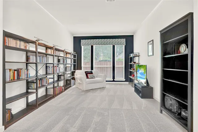 a bedroom with a bed and a lamp on dresser