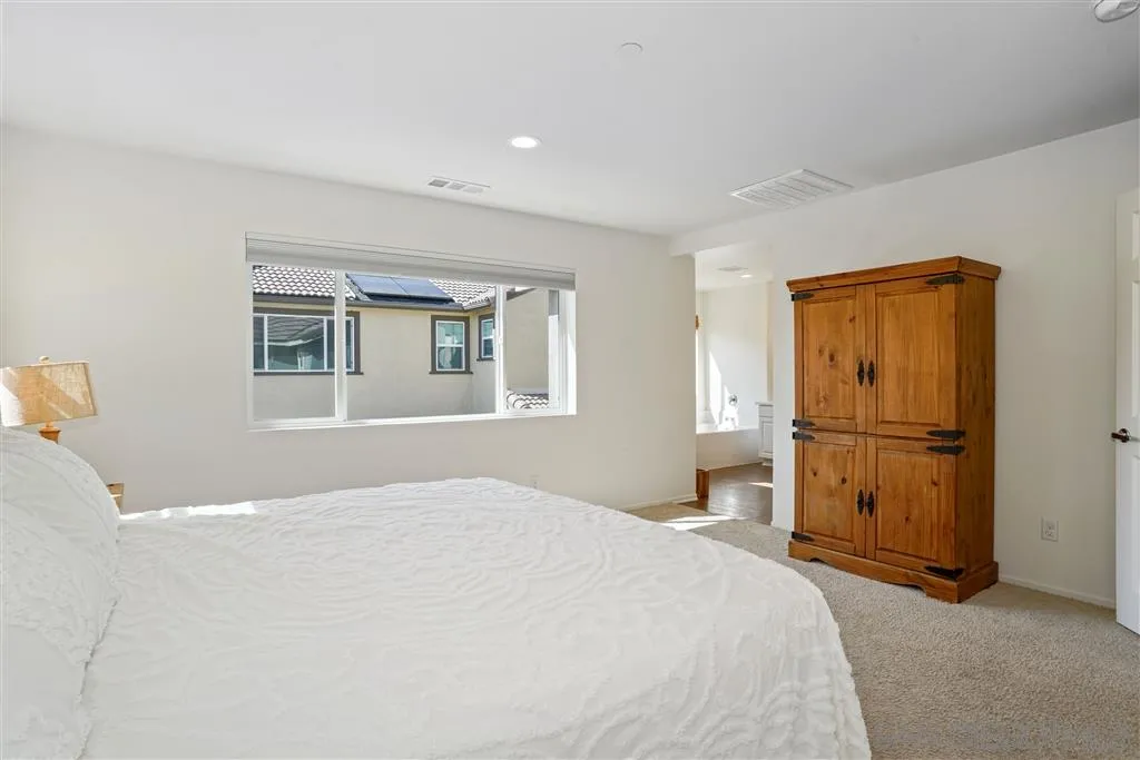 270 Oberlander Way Fallbrook, CA 92028 - Photo 12 of 23 a bedroom with a bed and wooden floor