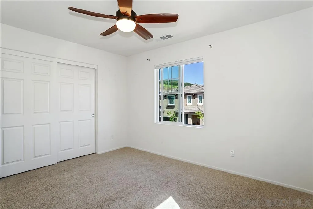 270 Oberlander Way Fallbrook, CA 92028 - Photo 17 of 23 an empty room with windows and fan