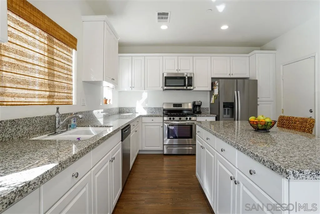 270 Oberlander Way Fallbrook, CA 92028 - Photo 3 of 23 a kitchen with stainless steel appliances granite countertop a sink stove and refrigerator