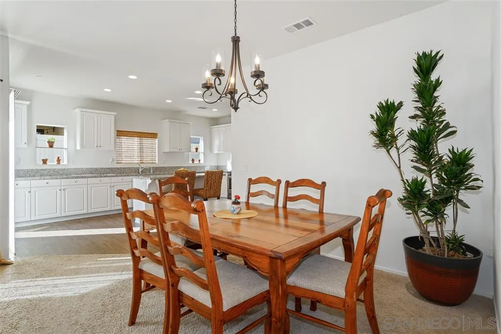 270 Oberlander Way Fallbrook, CA 92028 - Photo 4 of 23 a view of a dining room with furniture and potted plant