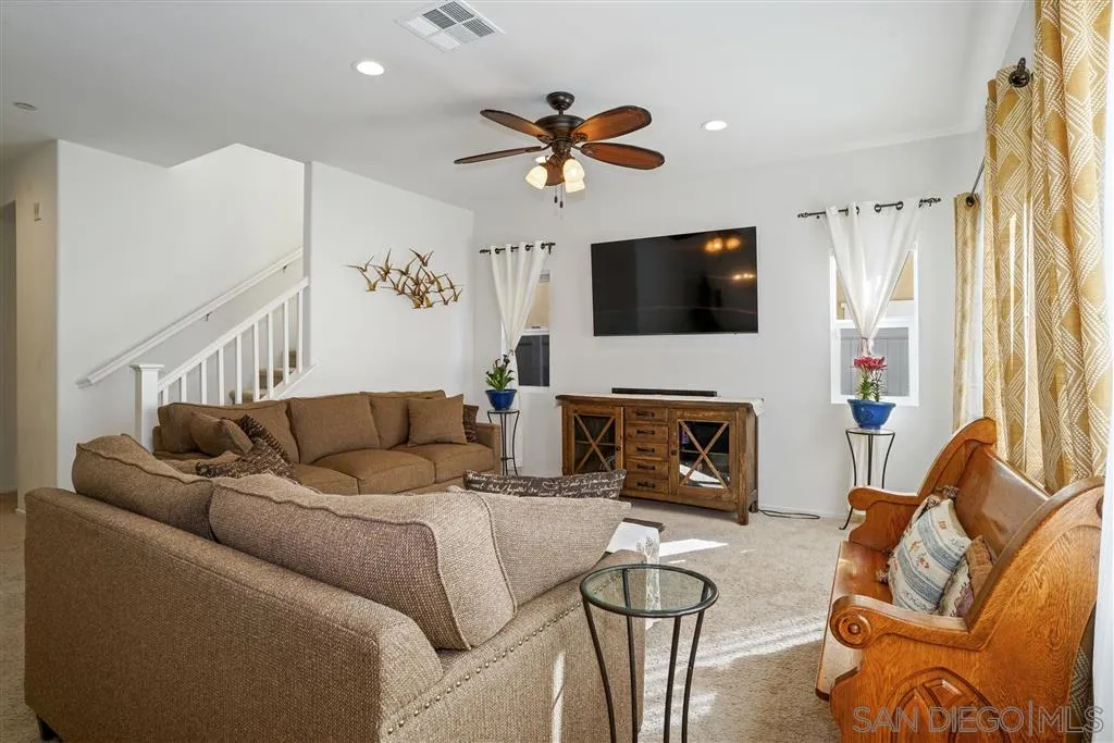 270 Oberlander Way Fallbrook, CA 92028 - Photo 7 of 23 a living room with furniture a fireplace and a flat screen tv