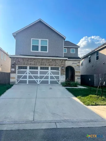 a front view of a house with yard