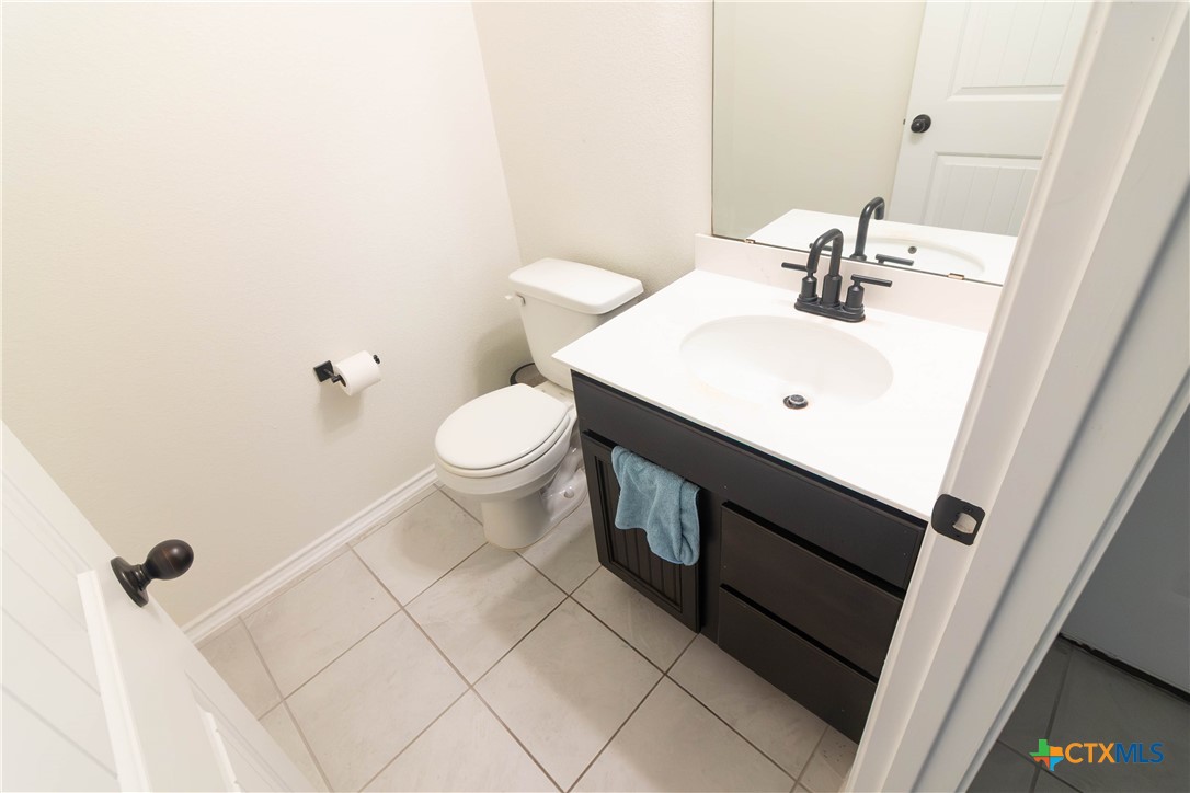 1131 Aronia Lane Georgetown, TX 78626 - Photo 12 of 36 a bathroom with a sink toilet and vanity