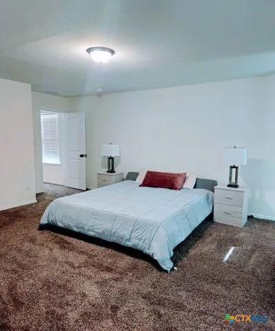 a bedroom with a bed and window