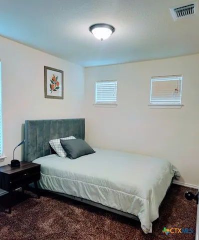 a bedroom with a bed and a table