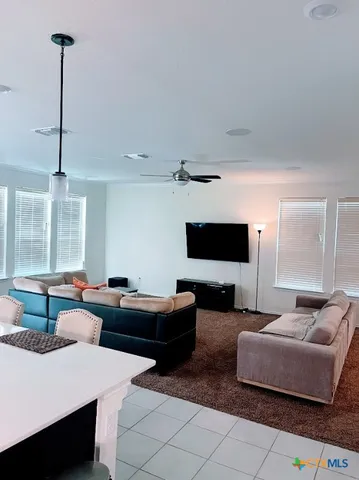 a living room with furniture and a flat screen tv