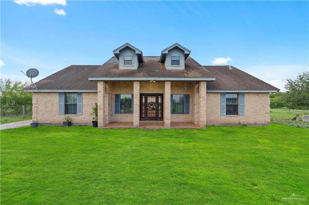 24175 Engleman Road Edcouch, TX 78538 - Photo 1 of 22 a front view of a house with a garden