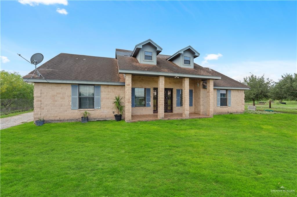 24175 Engleman Road Edcouch, TX 78538 - Photo 4 of 22 a front view of a house with a garden